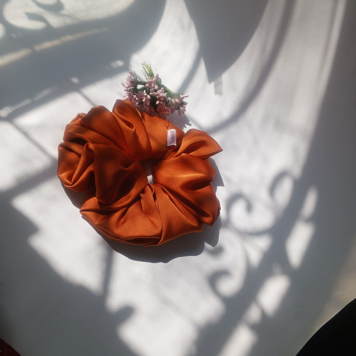 Scranchlab Rust Luxe Silk Scrunchie with pink flowers - top view