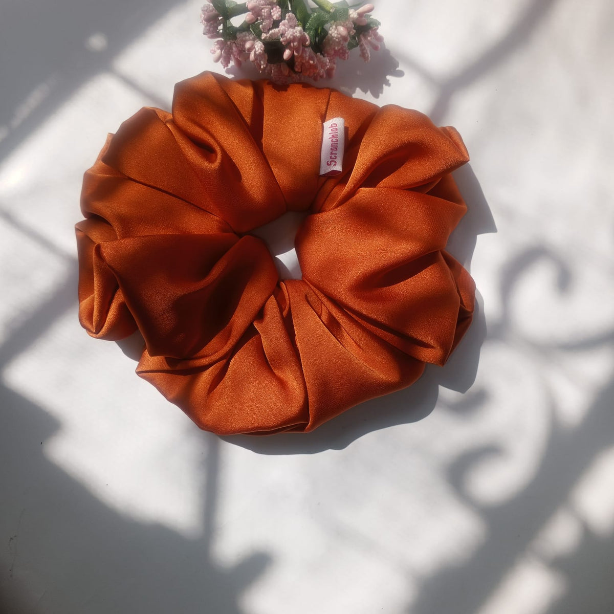 Scranchlab Rust Silk Scrunchie with perfume bottle styling