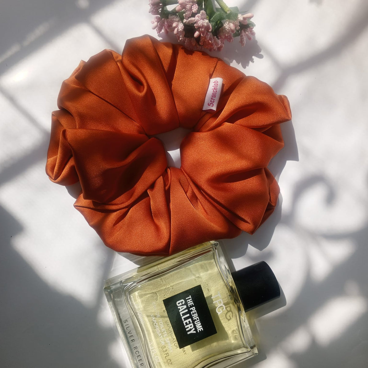 Scranchlab Rust Silk Scrunchie - lifestyle flat lay