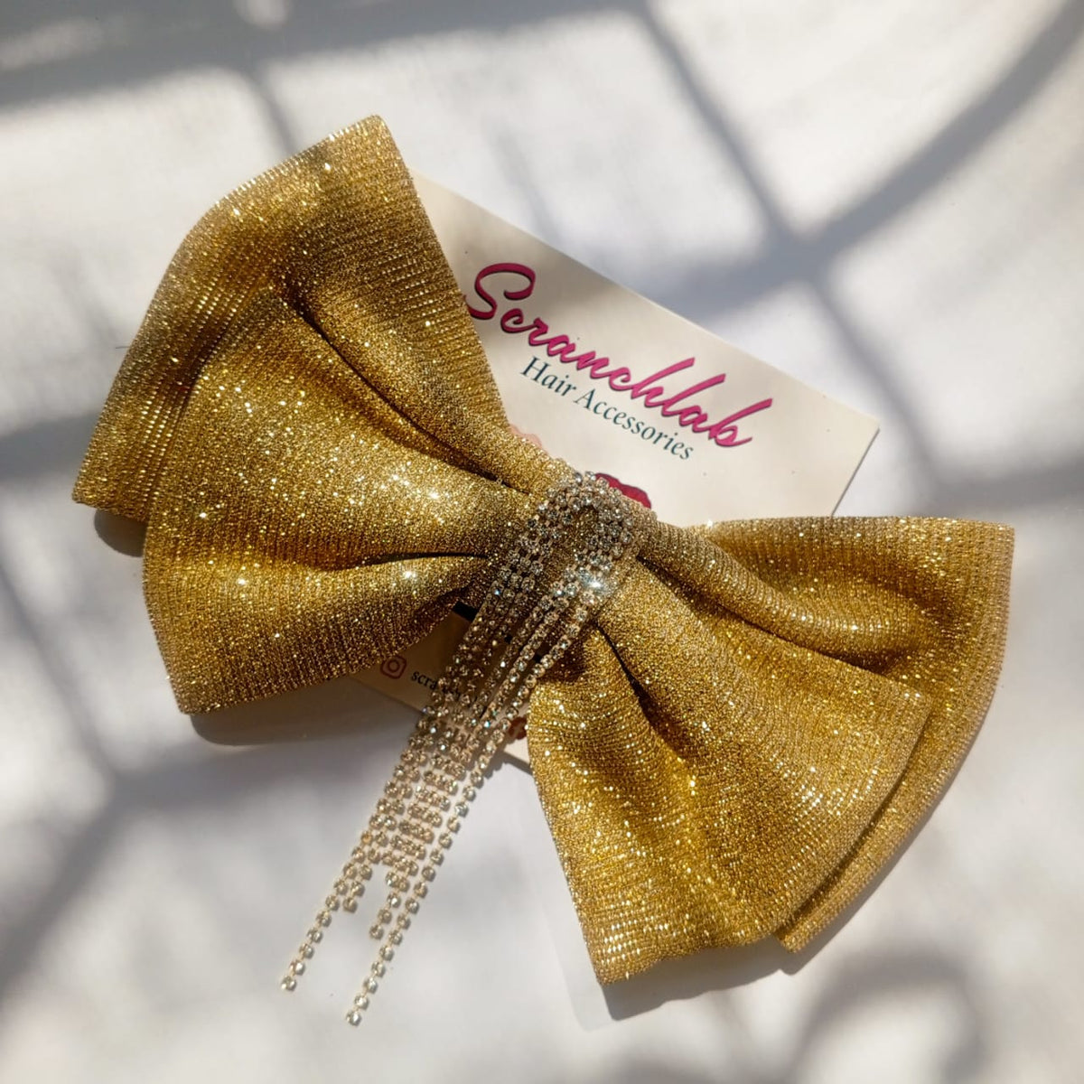 Scranchlab Aurora Gold Bow with crystal chains - front view
