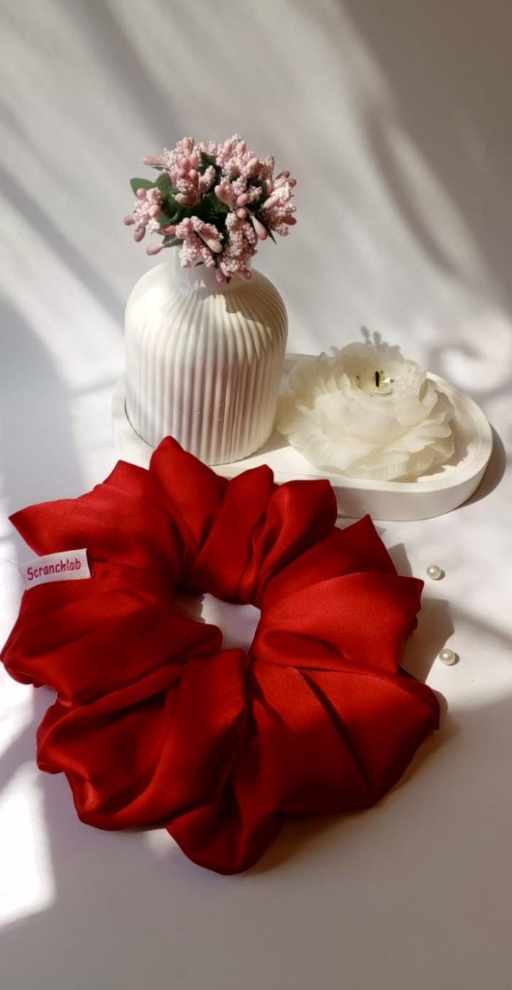 Scranchlab Cherry Red Silk Scrunchie - flat lay with pearls