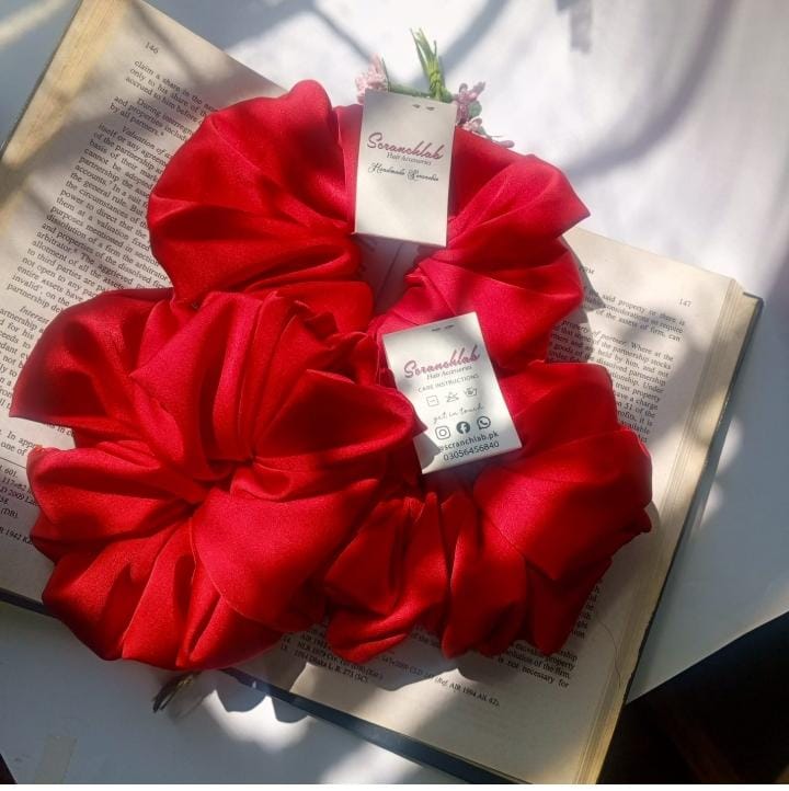 Scranchlab Cherry Red Silk Scrunchie - close up with vase and flowers