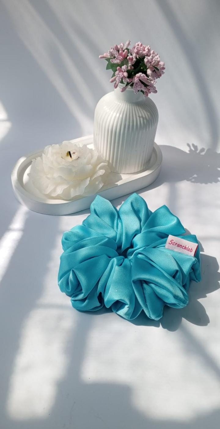 Scranchlab Ocean Teal Silk Scrunchie with white flower and vase - front view