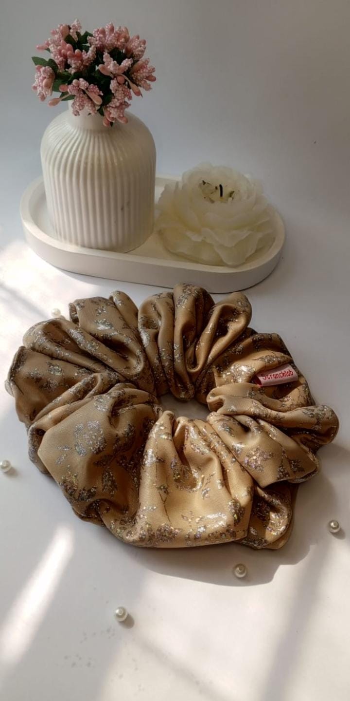 Scranchlab Muted Shimmer Silk Scrunchie - flat lay with pearls and white flower